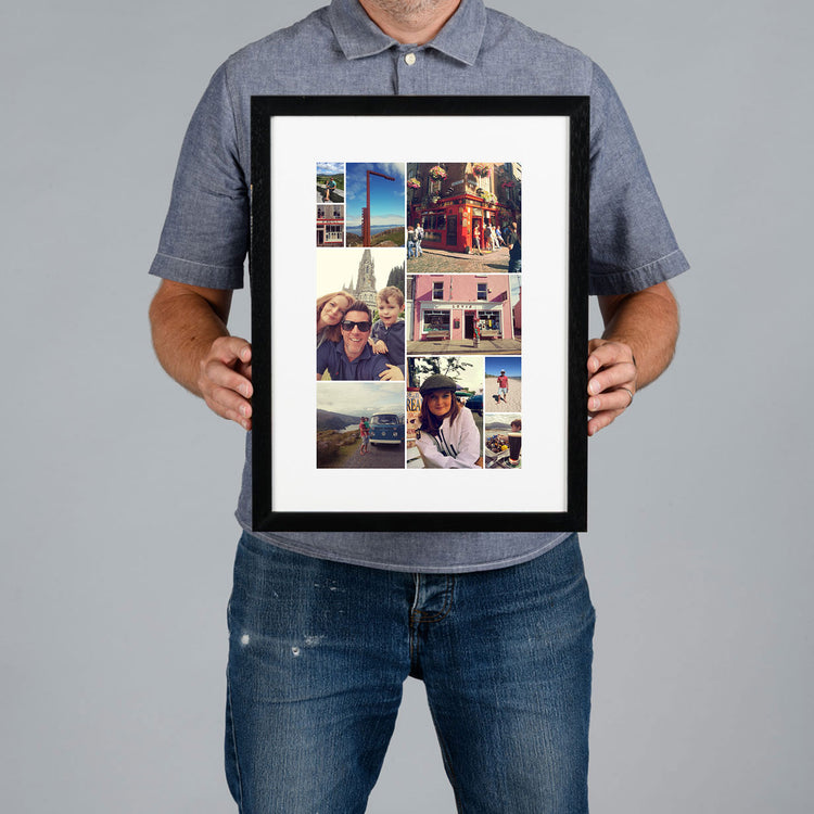A man holds a bespoke framed collage print against a plain gray studio background. The print has a black frame, white mat, and multiple travel and portrait photos arranged in a custom collage design. 