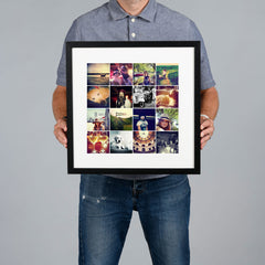 A man holds a black framed custom photo grid collage print against a solid gray background. The print is 30x30cm and the frame is 44x44cm. 